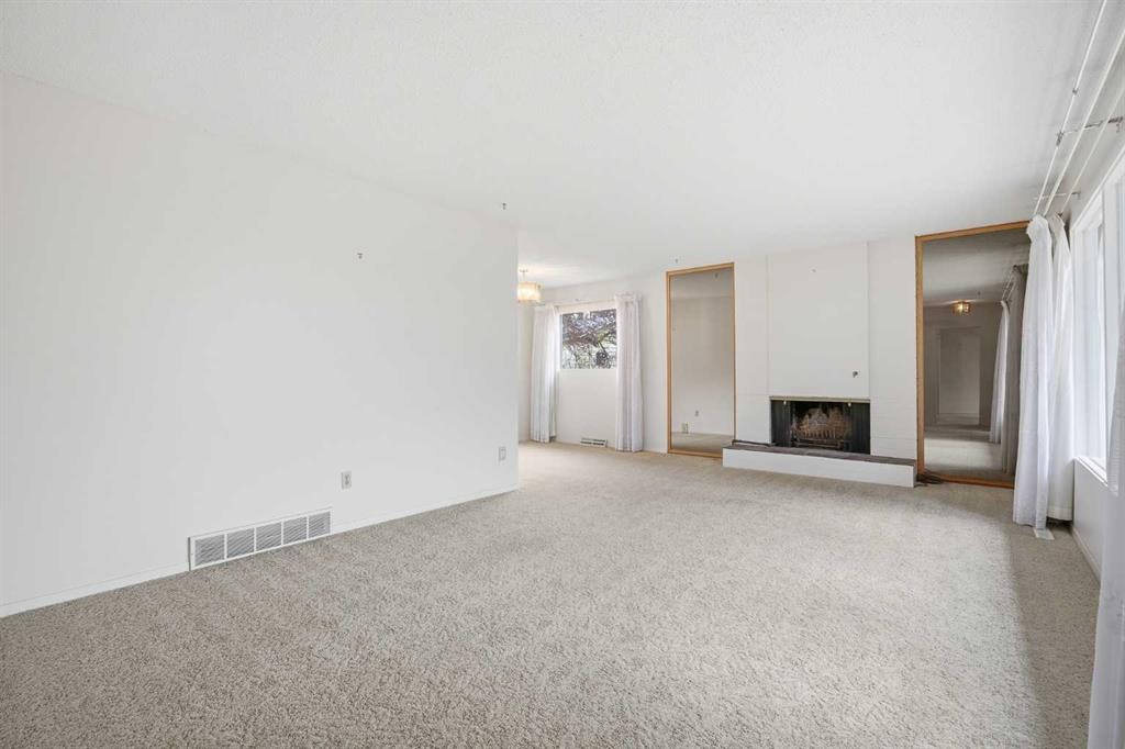 5220 Barron Drive Nw, Calgary, AB - Indoor Photo Showing Other Room With Fireplace
