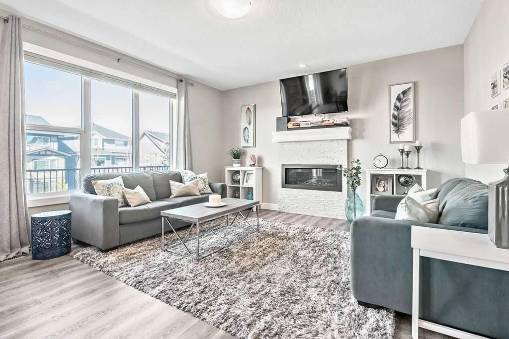 75 Sundown Way, Cochrane, AB - Indoor Photo Showing Living Room With Fireplace