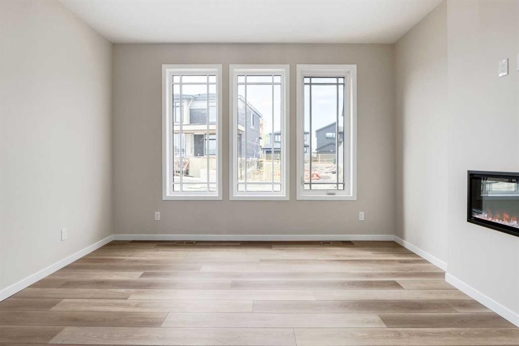 26 Alpine Gardens Sw, Calgary, AB - Indoor Photo Showing Other Room With Fireplace