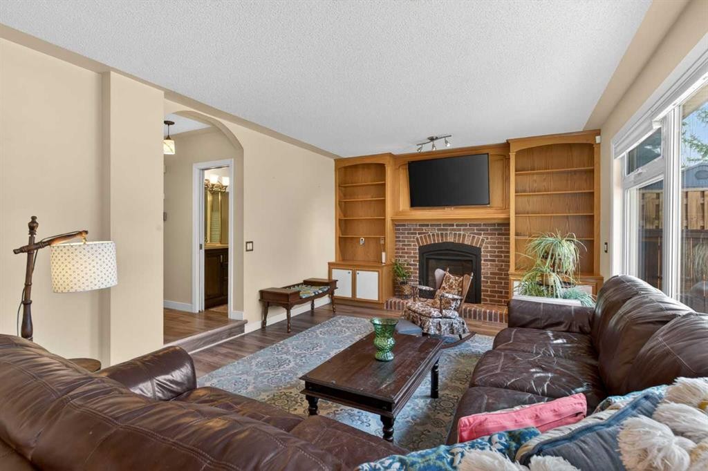 1486 Sunwood Road Se, Calgary, AB - Indoor Photo Showing Living Room With Fireplace