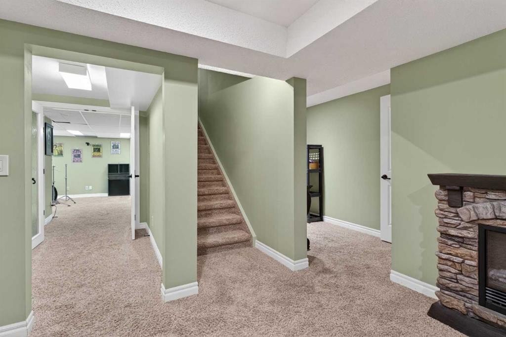 1486 Sunwood Road Se, Calgary, AB - Indoor Photo Showing Other Room With Fireplace
