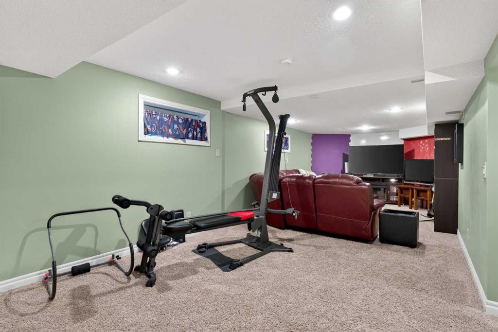 1486 Sunwood Road Se, Calgary, AB - Indoor Photo Showing Gym Room