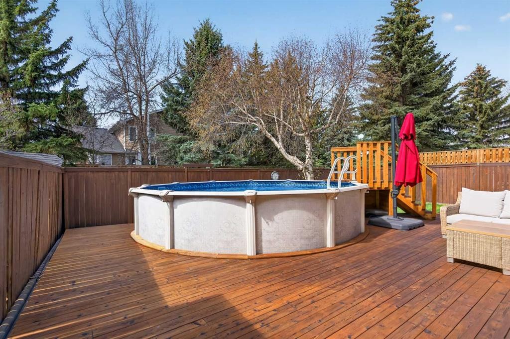 1486 Sunwood Road Se, Calgary, AB - Outdoor With Above Ground Pool With Deck Patio Veranda