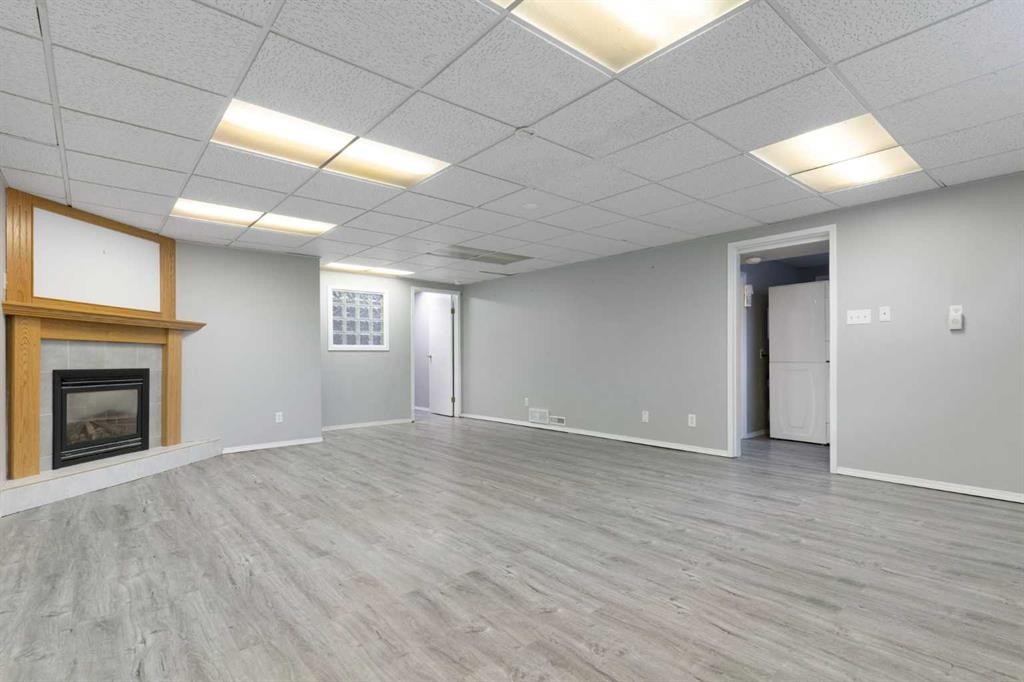 3228 Breen Crescent Nw, Calgary, AB - Indoor Photo Showing Basement With Fireplace