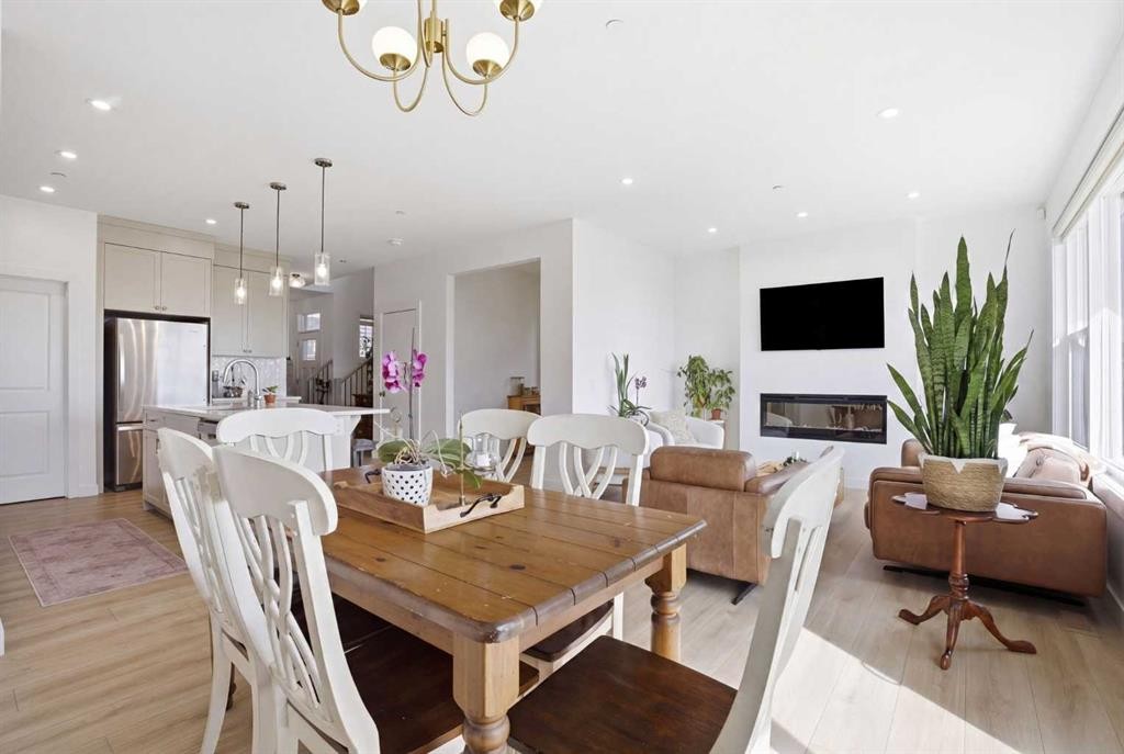 360 Calhoun Common Ne, Calgary, AB - Indoor Photo Showing Dining Room With Fireplace