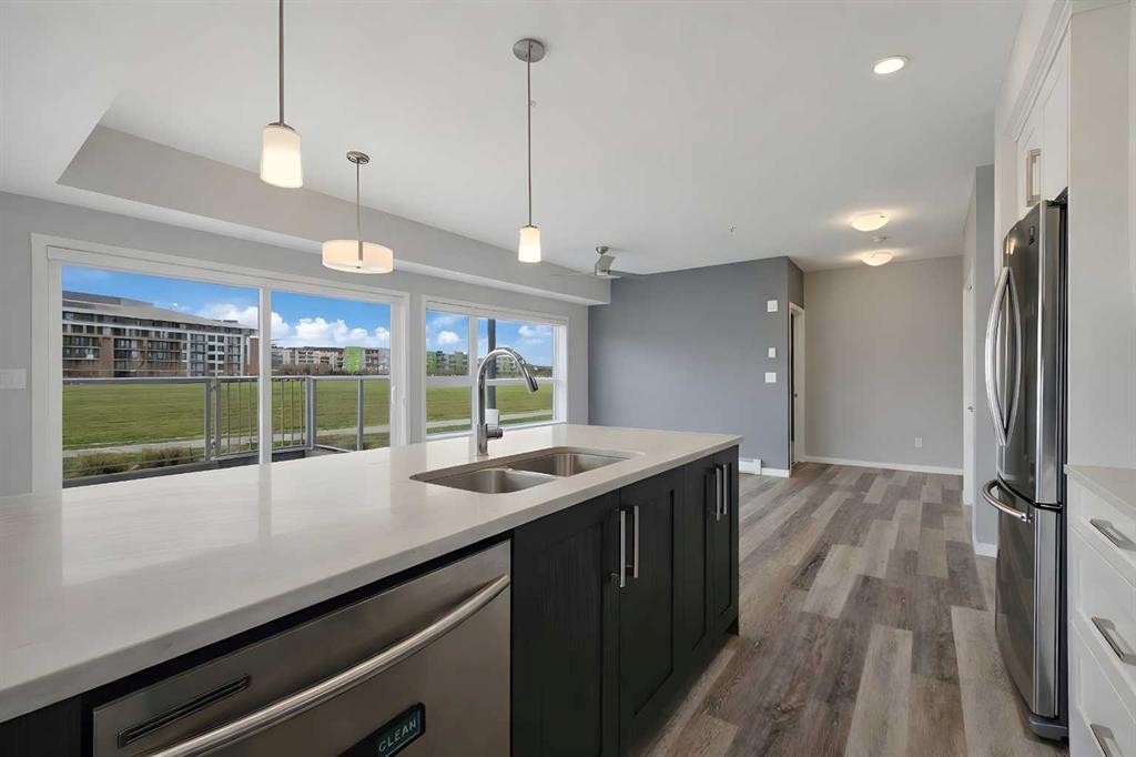 109-4150 Seton Drive Se, Calgary, AB - Indoor Photo Showing Kitchen With Stainless Steel Kitchen With Double Sink With Upgraded Kitchen