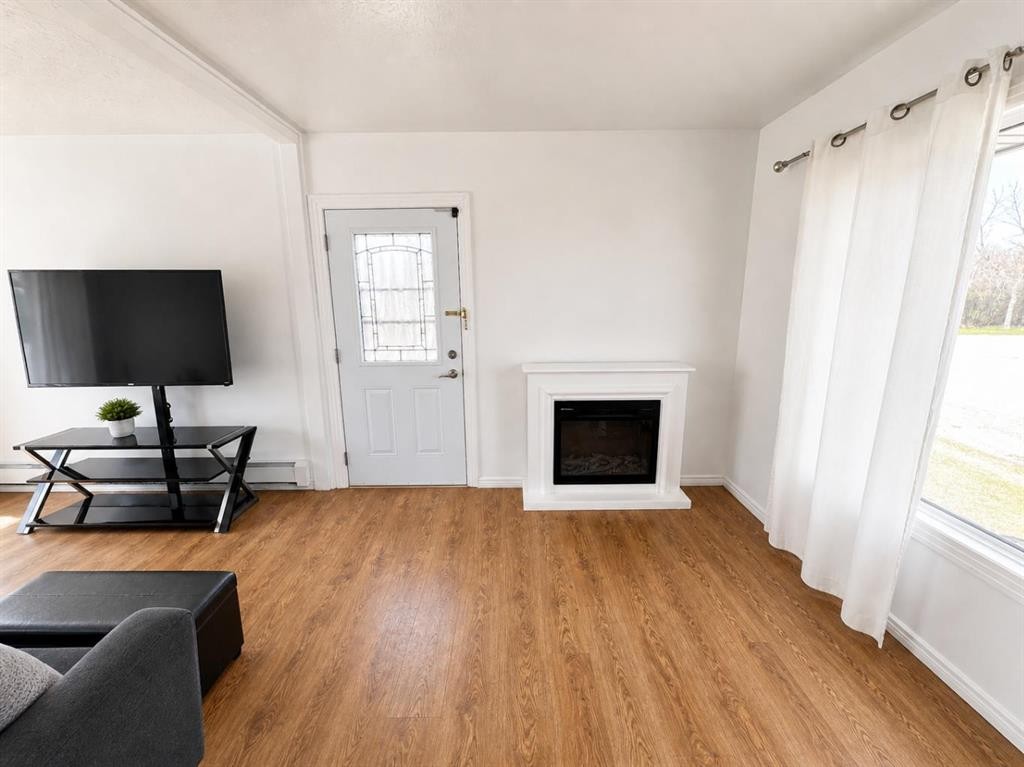 132 8 Avenue, Gleichen, AB - Indoor Photo Showing Living Room With Fireplace