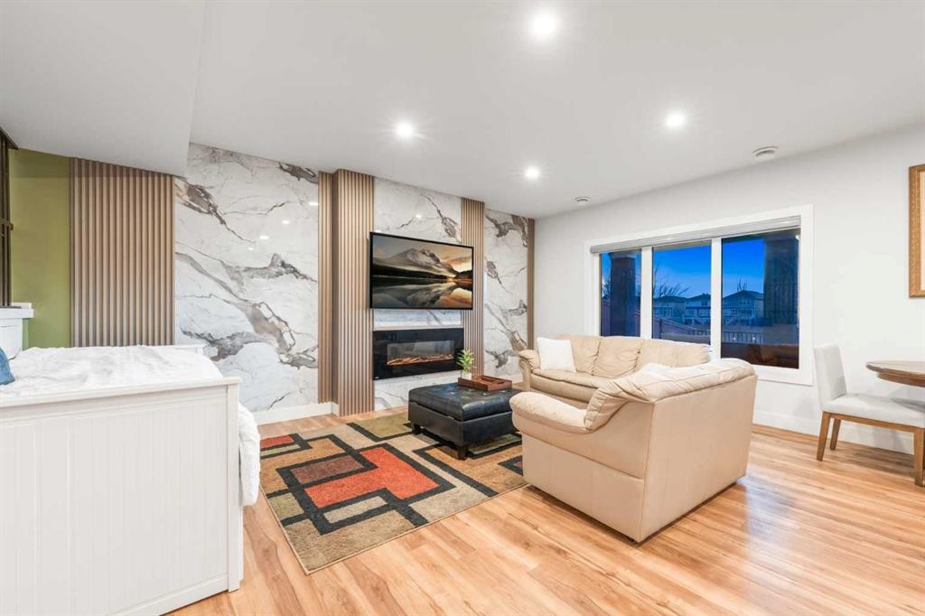 105 Carringvue Manor Nw, Calgary, AB - Indoor Photo Showing Living Room With Fireplace