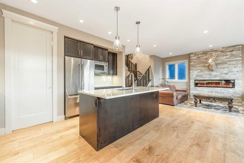 105 Carringvue Manor Nw, Calgary, AB - Indoor Photo Showing Kitchen With Fireplace With Upgraded Kitchen