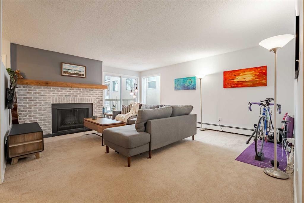7-3402 Parkdale Boulevard Nw, Calgary, AB - Indoor Photo Showing Living Room With Fireplace