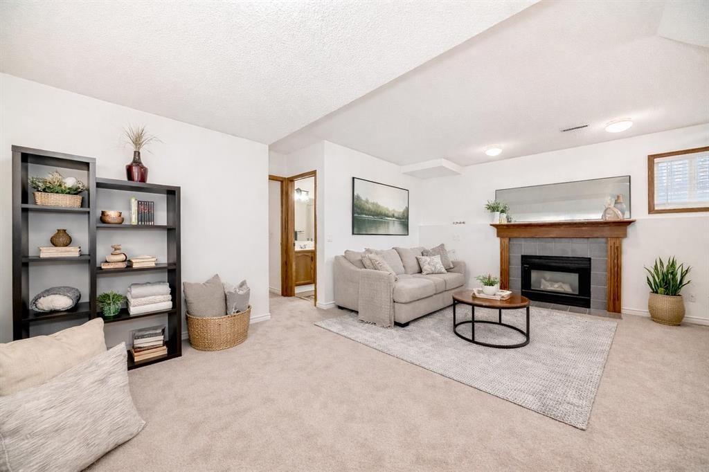 110 Erin Meadow Close Se, Calgary, AB - Indoor Photo Showing Living Room With Fireplace