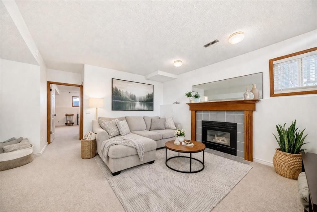 110 Erin Meadow Close Se, Calgary, AB - Indoor Photo Showing Living Room With Fireplace