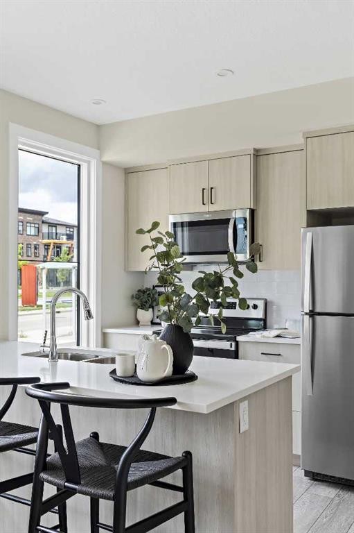 301-255 Rowmont Boulevard Nw, Calgary, AB - Indoor Photo Showing Kitchen With Upgraded Kitchen