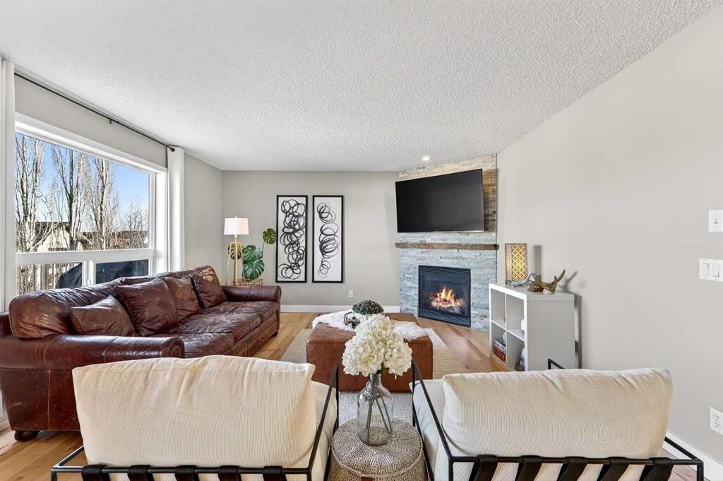95 Crestmont Drive Sw, Calgary, AB - Indoor Photo Showing Living Room With Fireplace