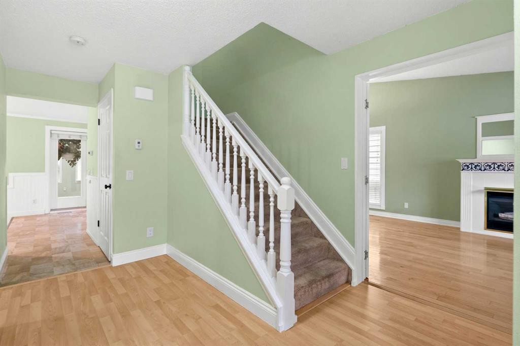 164 Sun Valley Drive Se, Calgary, AB - Indoor Photo Showing Other Room With Fireplace