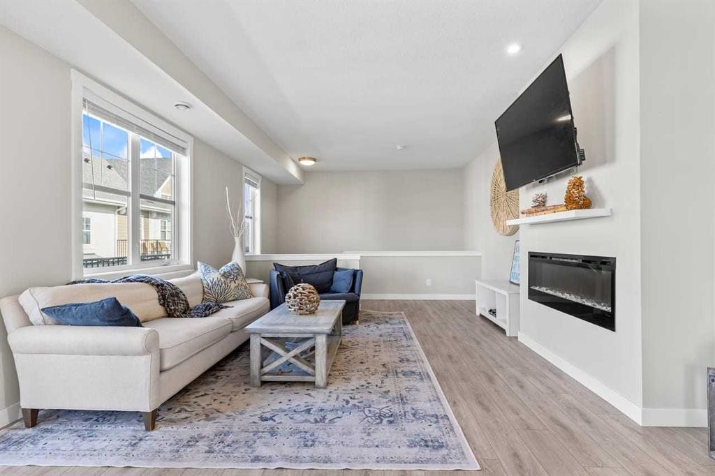 306 Cranbrook Walk Se, Calgary, AB - Indoor Photo Showing Living Room With Fireplace