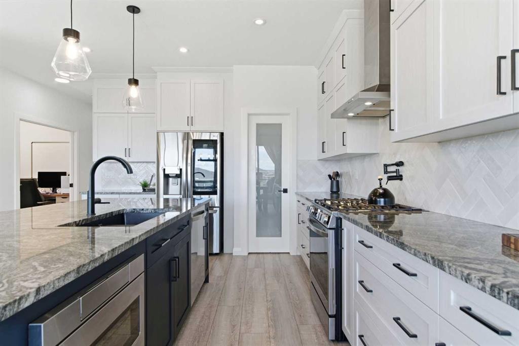 303 Rivercrest Boulevard, Cochrane, AB - Indoor Photo Showing Kitchen With Upgraded Kitchen