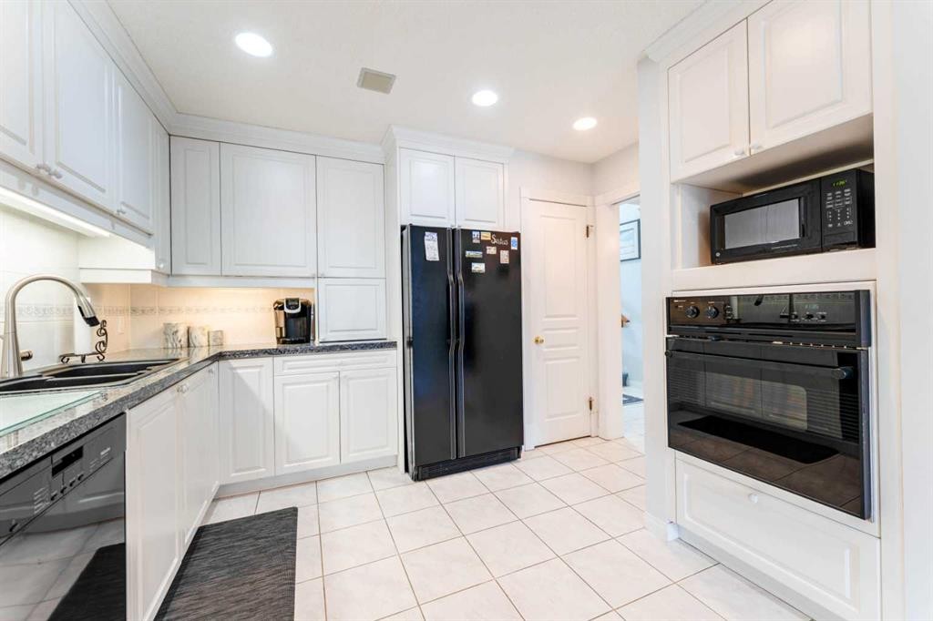 8 Prominence Path Sw, Calgary, AB - Indoor Photo Showing Kitchen With Double Sink