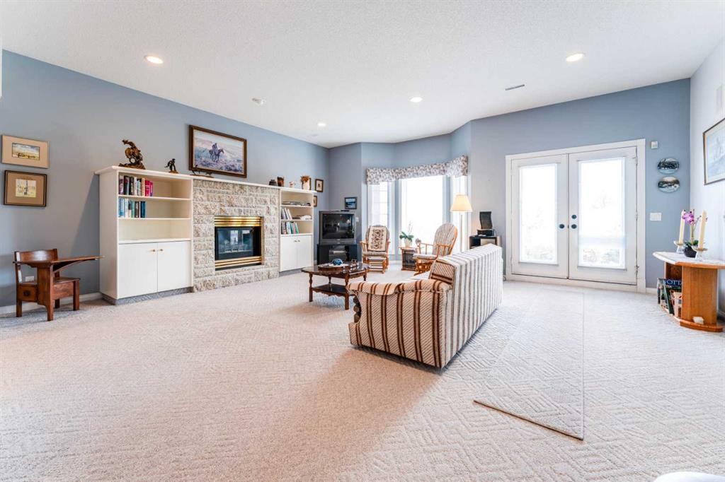 8 Prominence Path Sw, Calgary, AB - Indoor Photo Showing Living Room With Fireplace
