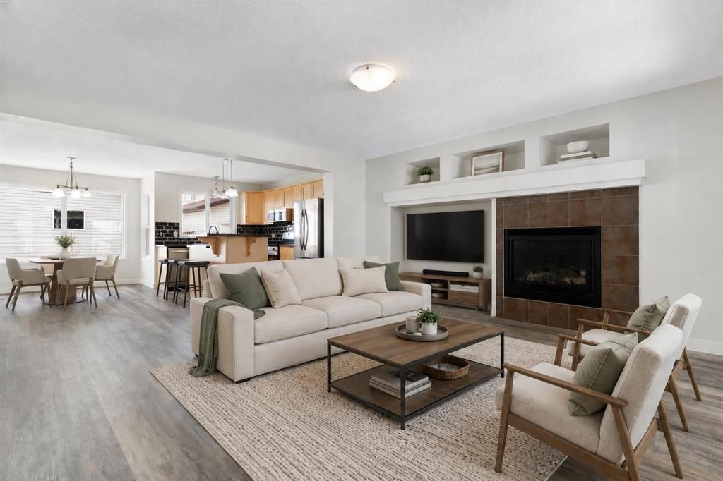 202 Sunset Heights, Cochrane, AB - Indoor Photo Showing Living Room With Fireplace