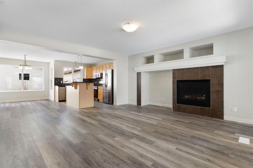 202 Sunset Heights, Cochrane, AB - Indoor Photo Showing Living Room With Fireplace