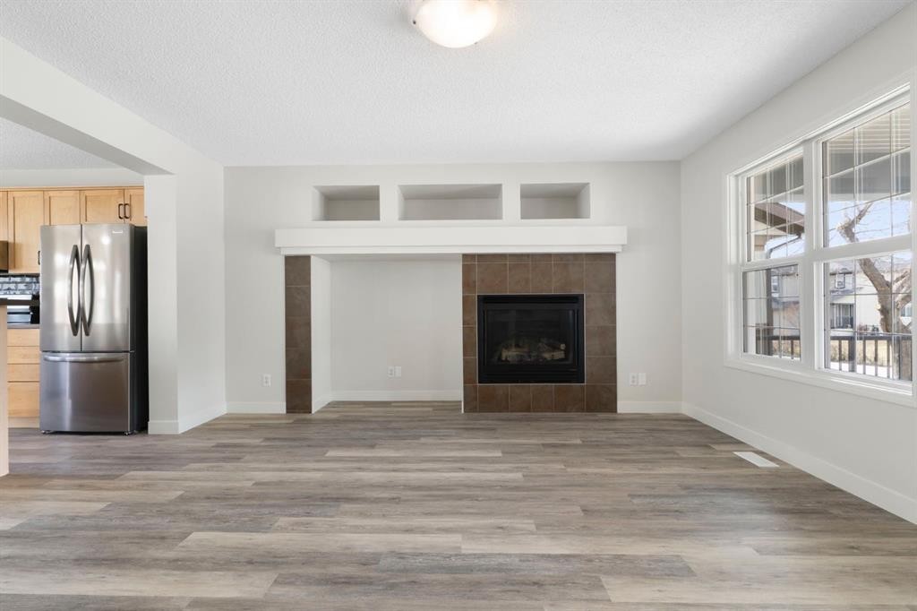 202 Sunset Heights, Cochrane, AB - Indoor Photo Showing Living Room With Fireplace
