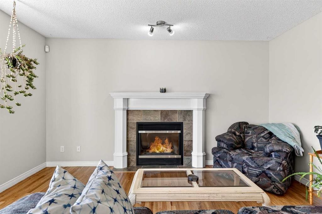 99 Evansmeade Crescent Nw, Calgary, AB - Indoor Photo Showing Living Room With Fireplace