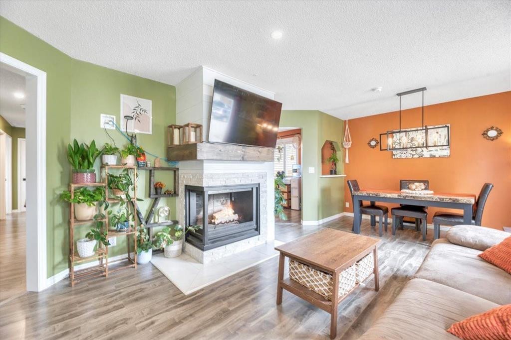 112 Thorson Crescent, Okotoks, AB - Indoor Photo Showing Living Room With Fireplace