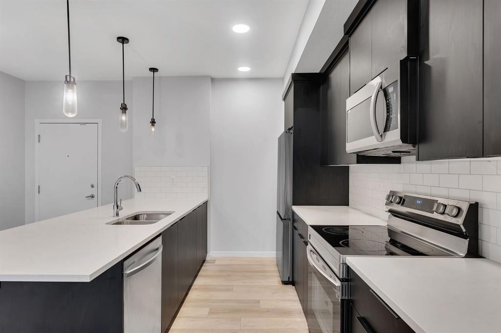 3201-220 Seton Grove Se, Calgary, AB - Indoor Photo Showing Kitchen With Stainless Steel Kitchen With Double Sink With Upgraded Kitchen