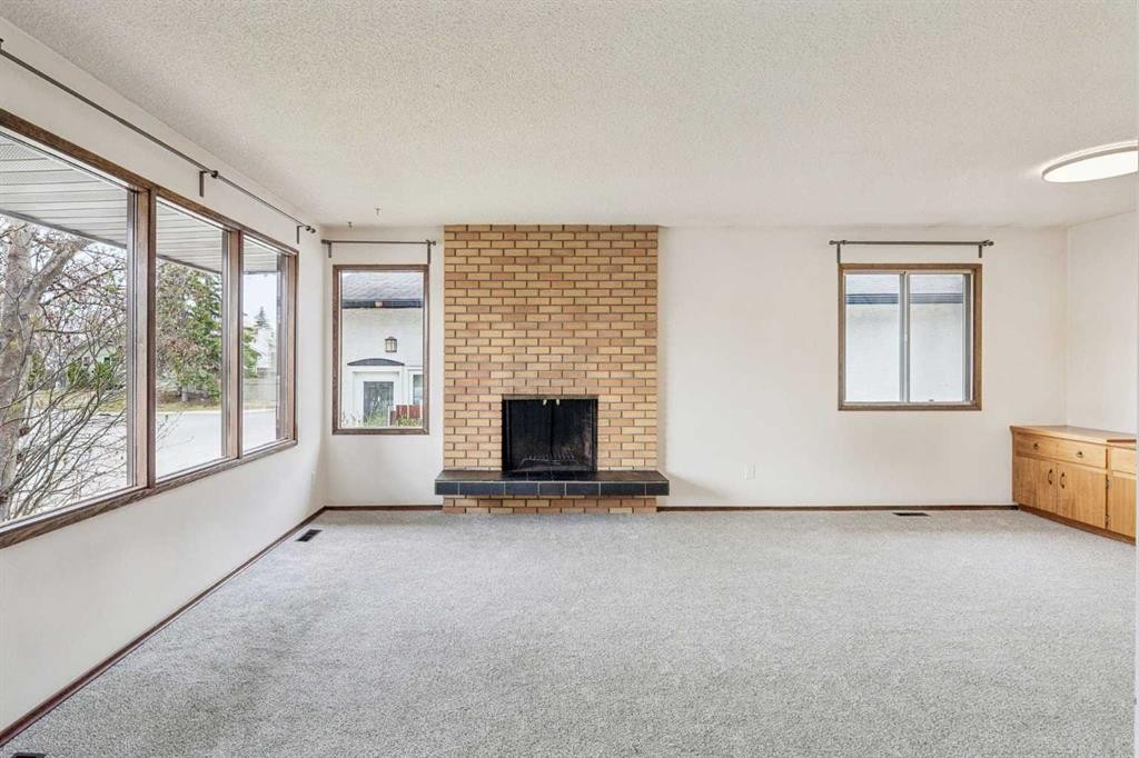 1260 Lake Sylvan Drive Se, Calgary, AB - Indoor Photo Showing Other Room With Fireplace