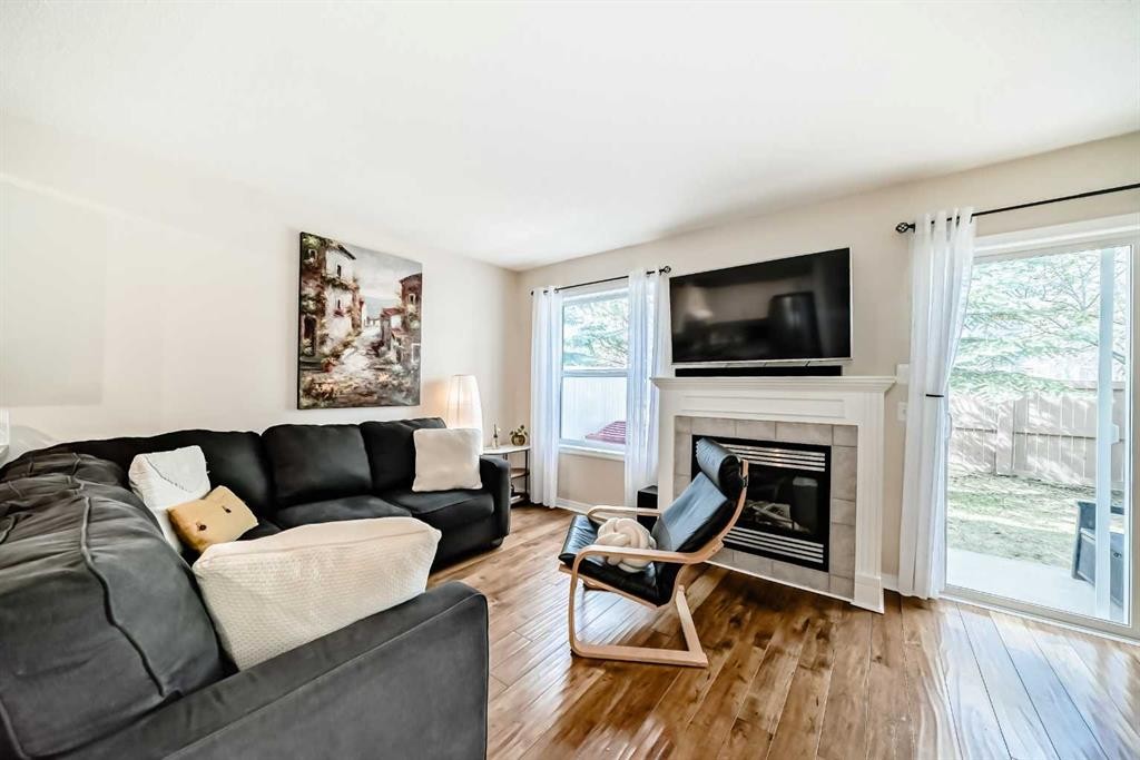 103 Everstone Place Sw, Calgary, AB - Indoor Photo Showing Living Room With Fireplace