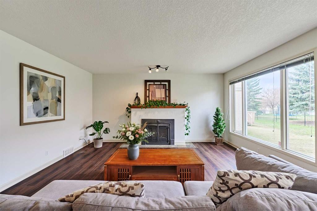 243 Hampshire Close Nw, Calgary, AB - Indoor Photo Showing Living Room With Fireplace