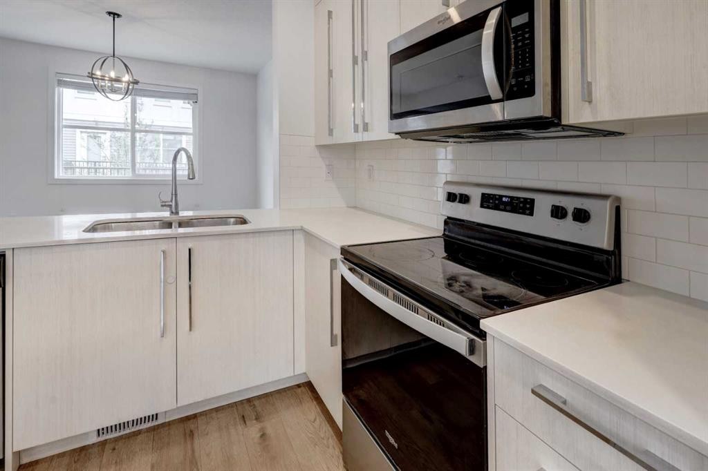 705-50 Cornerstone Passage Ne, Calgary, AB - Indoor Photo Showing Kitchen With Double Sink