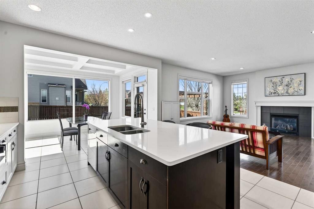 421 Auburn Bay Boulevard Se, Calgary, AB - Indoor Photo Showing Kitchen With Fireplace With Double Sink