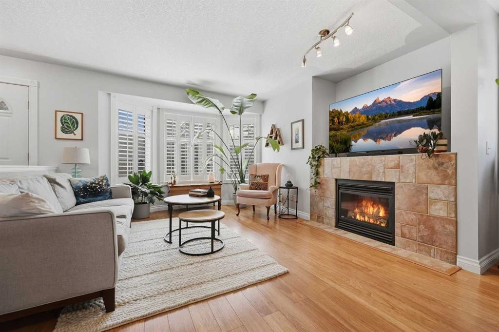 450 Regal Park Ne, Calgary, AB - Indoor Photo Showing Living Room With Fireplace