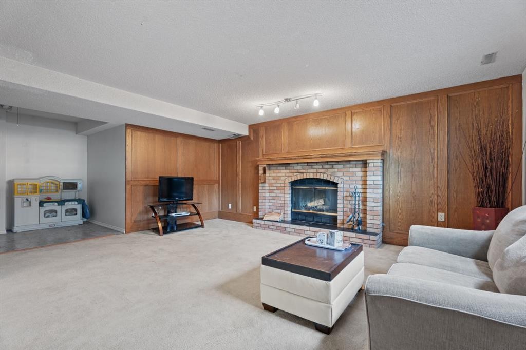 133 Carr Crescent, Okotoks, AB - Indoor Photo Showing Living Room With Fireplace