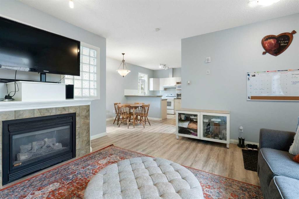 210-5703 5 Street Sw, Calgary, AB - Indoor Photo Showing Living Room With Fireplace