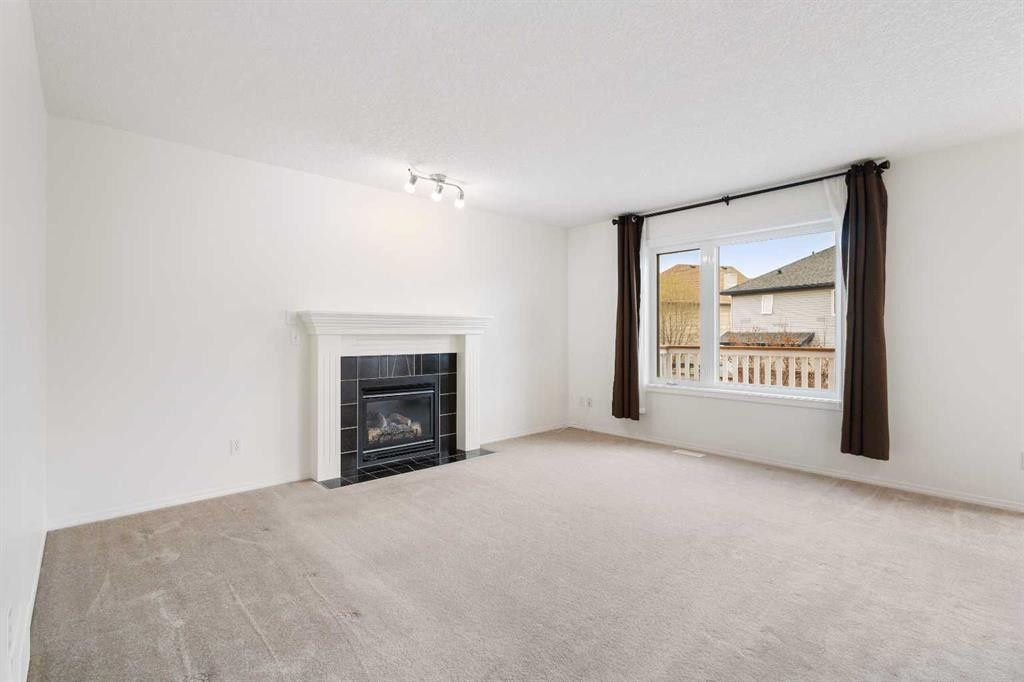 112 Everridge Drive Sw, Calgary, AB - Indoor Photo Showing Living Room With Fireplace
