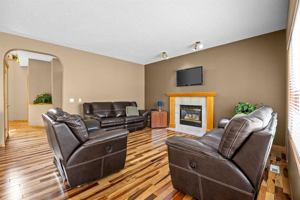 30 Gleneagles View, Cochrane, AB - Indoor Photo Showing Living Room With Fireplace