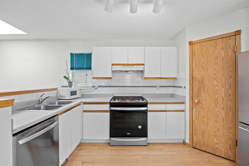 242 Hidden Spring Mews Nw, Calgary, AB - Indoor Photo Showing Kitchen With Double Sink