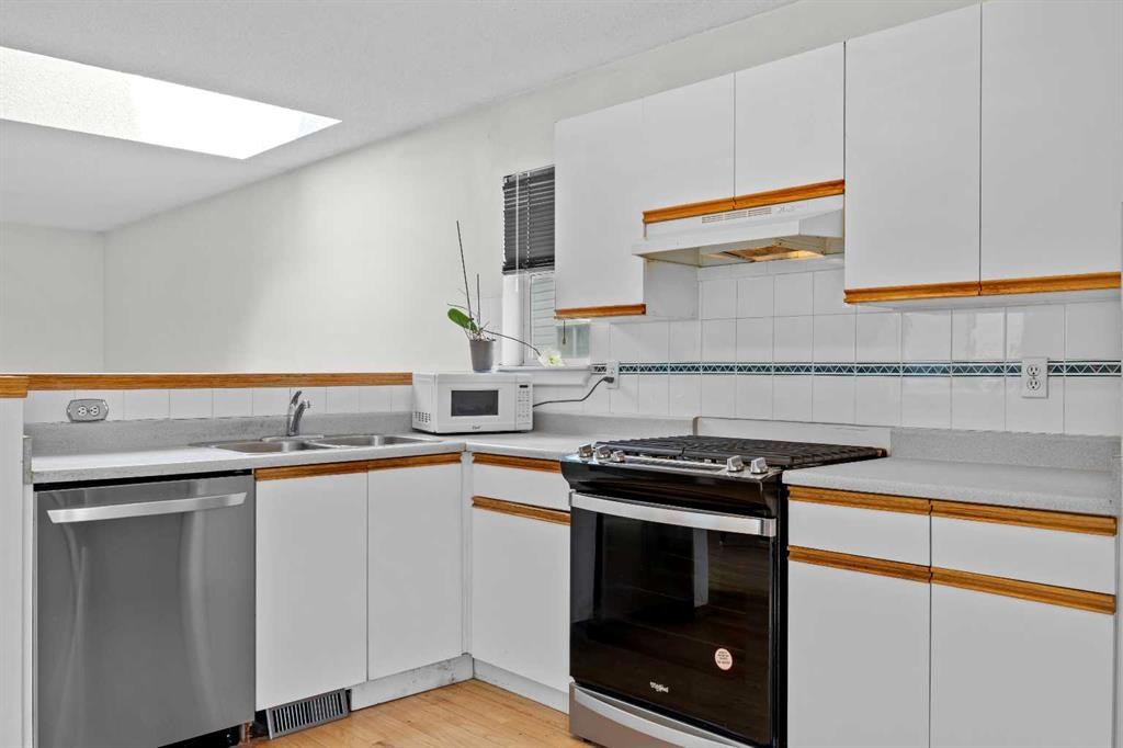 242 Hidden Spring Mews Nw, Calgary, AB - Indoor Photo Showing Kitchen With Double Sink