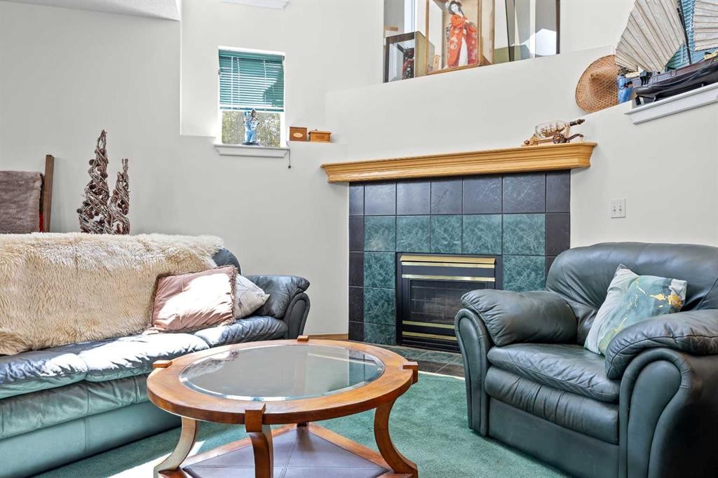 242 Hidden Spring Mews Nw, Calgary, AB - Indoor Photo Showing Other Room With Fireplace