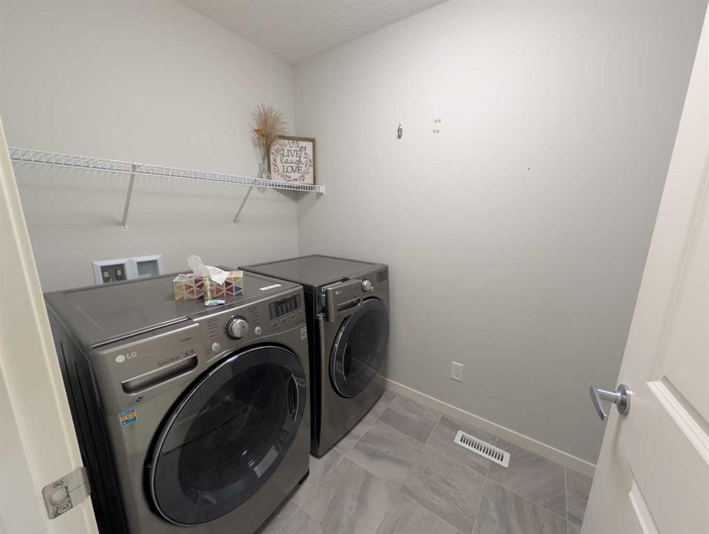54 Seton Manor Se, Calgary, AB - Indoor Photo Showing Laundry Room