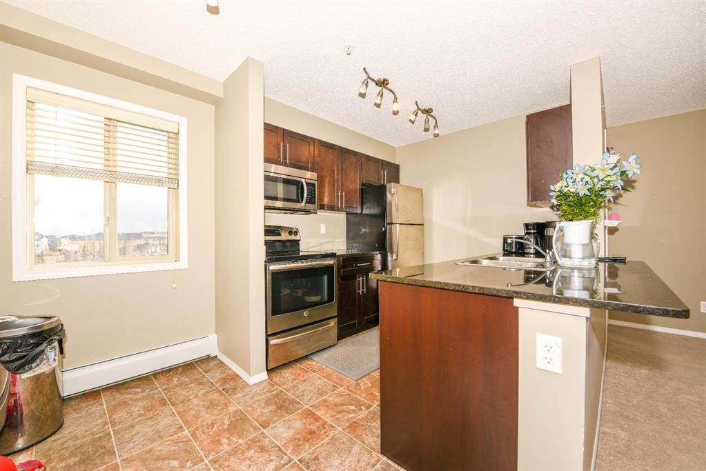 302-5 Saddlestone Way Ne, Calgary, AB - Indoor Photo Showing Kitchen With Stainless Steel Kitchen