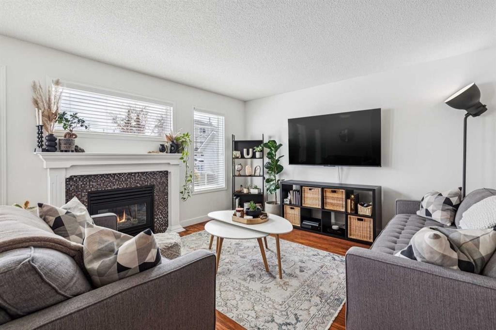 94 West Springs Way Sw, Calgary, AB - Indoor Photo Showing Living Room With Fireplace