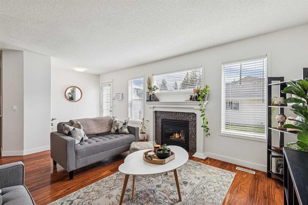94 West Springs Way Sw, Calgary, AB - Indoor Photo Showing Living Room With Fireplace