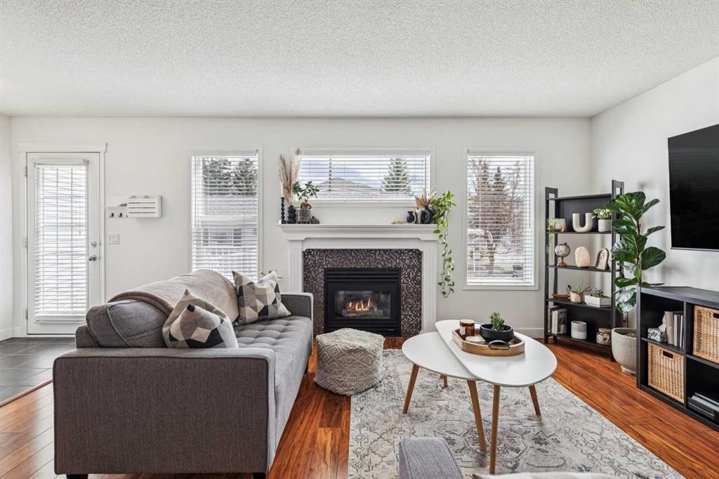 94 West Springs Way Sw, Calgary, AB - Indoor Photo Showing Living Room With Fireplace