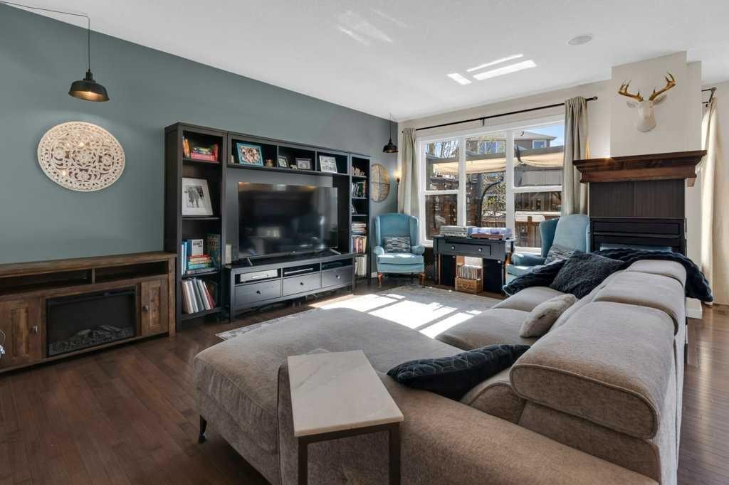 26 Heritage Landing, Cochrane, AB - Indoor Photo Showing Living Room With Fireplace