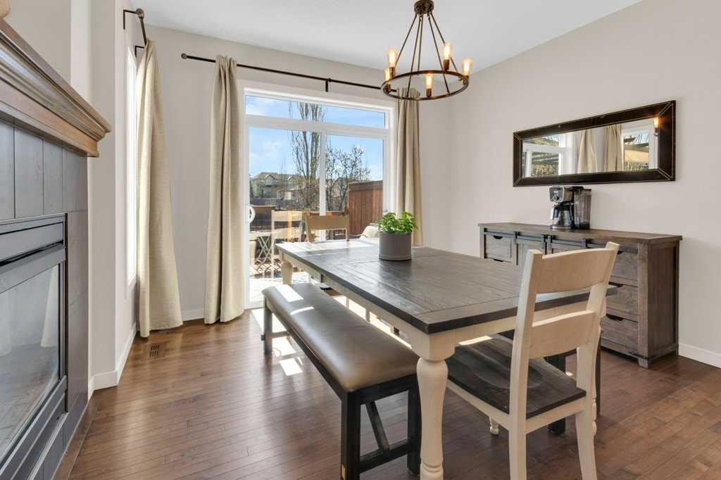 26 Heritage Landing, Cochrane, AB - Indoor Photo Showing Dining Room With Fireplace