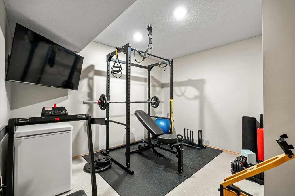90 Elgin Drive Se, Calgary, AB - Indoor Photo Showing Gym Room